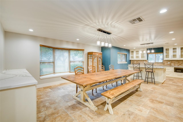 4438 Wigton Dr, Houston, TX 77096 - dining space featuring recessed lighting, stone tile floors, and baseboards