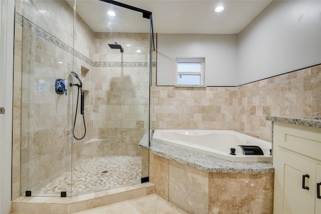 4438 Wigton Dr, Houston, TX 77096 - full bathroom featuring a shower stall, a bath, tile walls, vanity, and recessed lighting