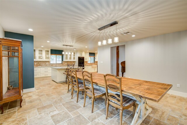 4438 Wigton Dr, Houston, TX 77096 - dining room featuring recessed lighting, light stone finish flooring, and baseboards