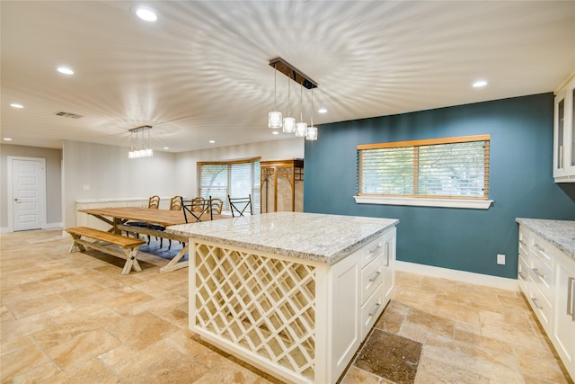 4438 Wigton Dr, Houston, TX 77096 - kitchen featuring stone tile floors, white cabinets, recessed lighting, baseboards, and decorative light fixtures