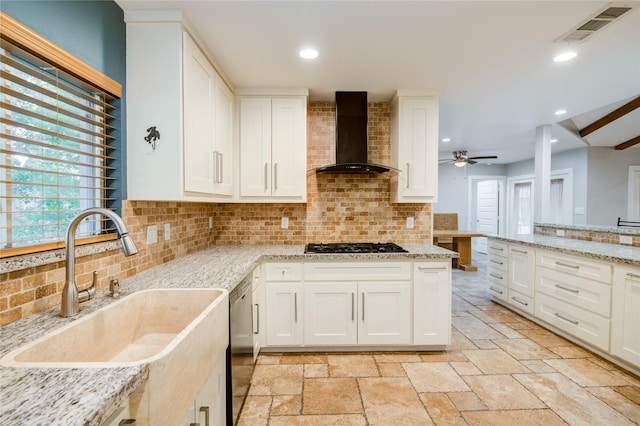 4438 Wigton Dr, Houston, TX 77096 - kitchen featuring wall chimney range hood, a sink, dishwashing machine, backsplash, and recessed lighting