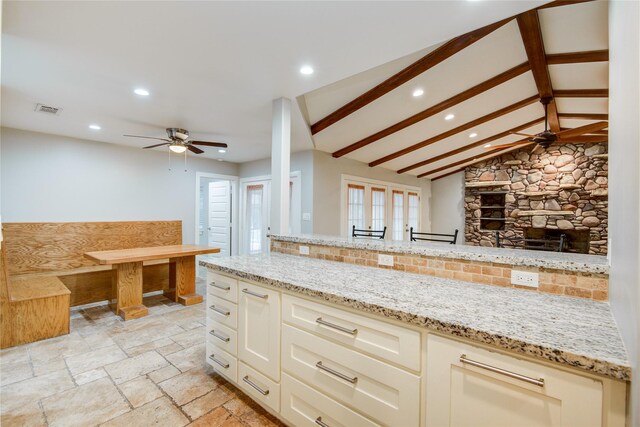 4438 Wigton Dr, Houston, TX 77096 - kitchen featuring a ceiling fan, recessed lighting, light stone countertops, stone tile flooring, and open floor plan