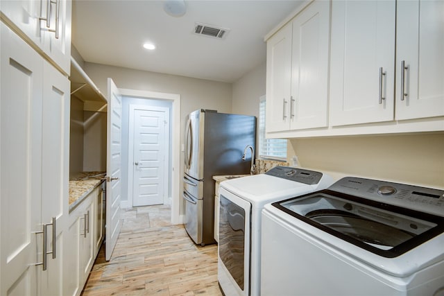 4438 Wigton Dr, Houston, TX 77096 - washroom with washing machine and clothes dryer, light wood-type flooring, cabinet space, recessed lighting, and baseboards