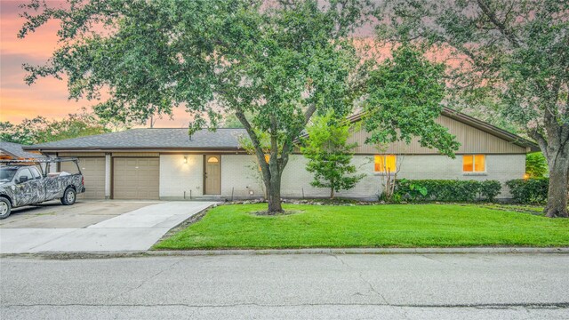 4438 Wigton Dr, Houston, TX 77096 - view of front of home with brick siding, an attached garage, a front lawn, and concrete driveway