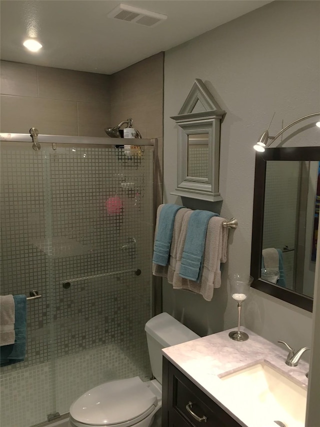 4747 Nasa Pkwy Unit 104, Pasadena, TX 77586 - bathroom featuring toilet, a shower stall, and vanity
