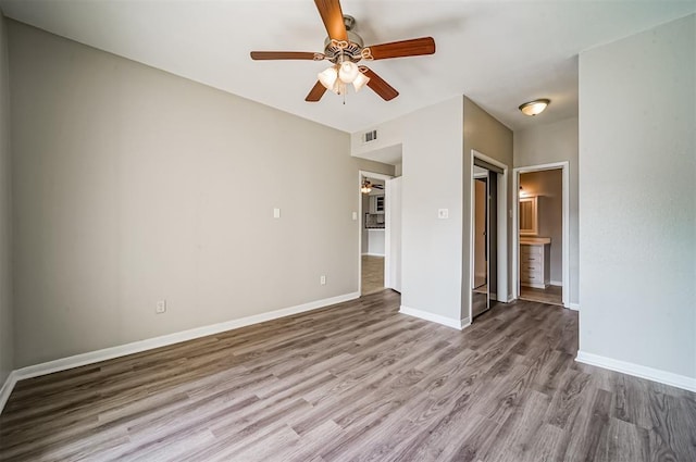 4747 Nasa Pkwy Unit 104, Pasadena, TX 77586 - unfurnished bedroom featuring wood finished floors, baseboards, and ceiling fan