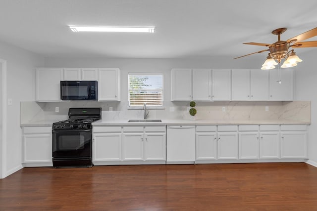 7918 Swan Ln, Baytown, TX 77523 - kitchen featuring black appliances, a sink, backsplash, ceiling fan, and white cabinets