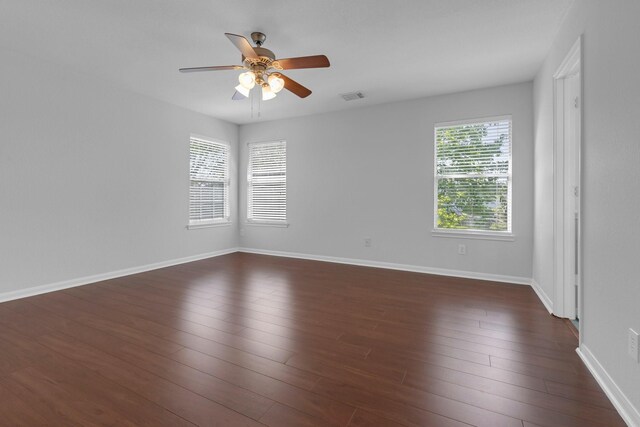 7918 Swan Ln, Baytown, TX 77523 - unfurnished room featuring a ceiling fan, dark wood finished floors, and baseboards