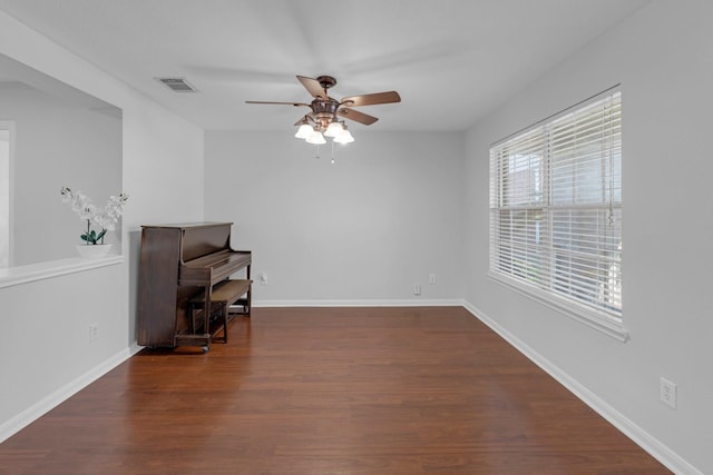 7918 Swan Ln, Baytown, TX 77523 - spare room featuring a ceiling fan, wood finished floors, and baseboards