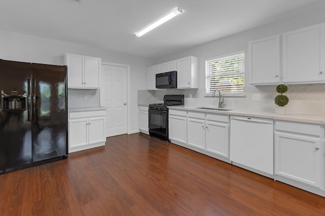 7918 Swan Ln, Baytown, TX 77523 - kitchen featuring black appliances, a sink, light countertops, dark wood-type flooring, and white cabinetry