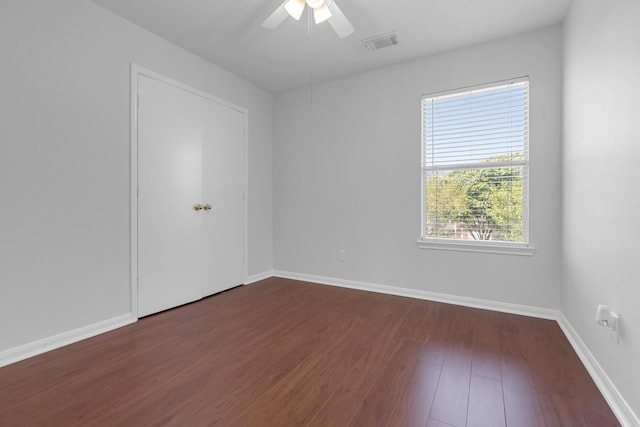 7918 Swan Ln, Baytown, TX 77523 - spare room featuring dark wood finished floors, ceiling fan, and baseboards