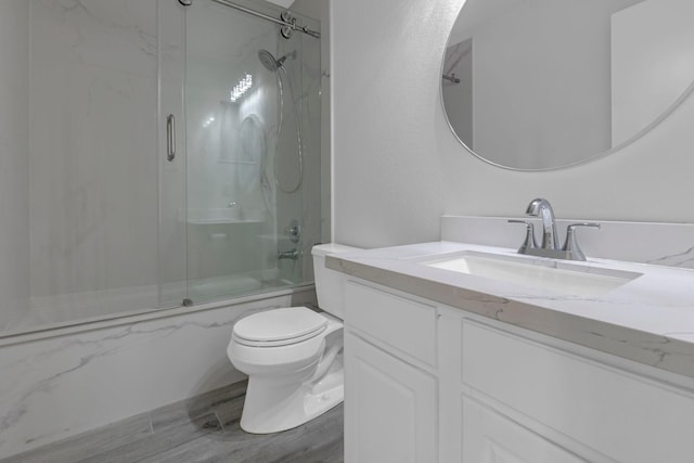 7918 Swan Ln, Baytown, TX 77523 - bathroom with toilet, vanity, and bath / shower combo with glass door