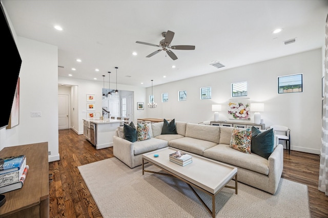 living room featuring ceiling fan, dark wood finished floors, recessed lighting, and baseboards