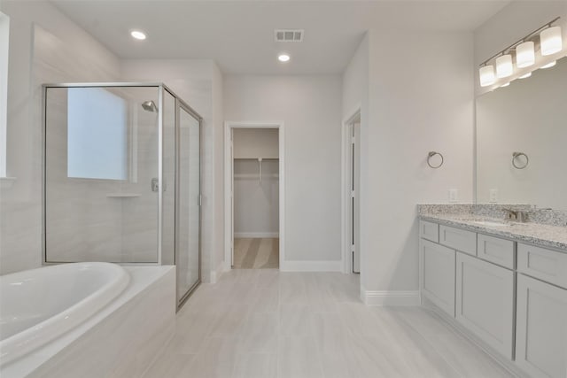 13140 Soaring Forest Dr, Conroe, TX 77302 - full bathroom with a stall shower, vanity, a spacious closet, and a garden tub