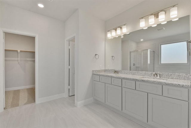 13140 Soaring Forest Dr, Conroe, TX 77302 - full bathroom with a shower stall, a walk in closet, double vanity, baseboards, and recessed lighting