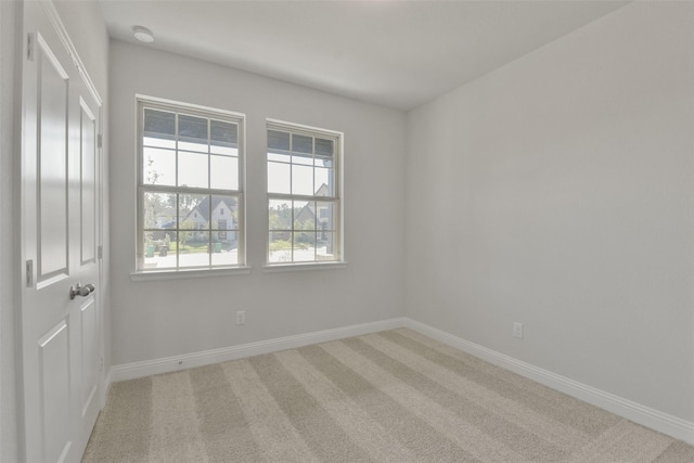 13140 Soaring Forest Dr, Conroe, TX 77302 - unfurnished room featuring light carpet, baseboards, and a smoke detector