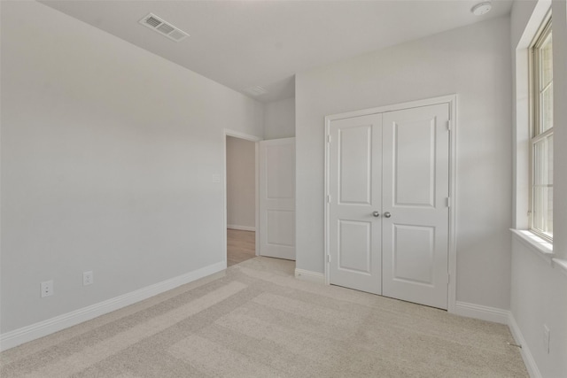 13140 Soaring Forest Dr, Conroe, TX 77302 - unfurnished bedroom with light colored carpet, a closet, and baseboards