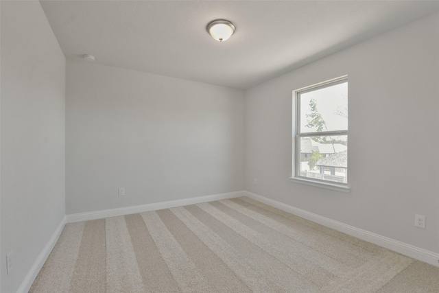 13140 Soaring Forest Dr, Conroe, TX 77302 - empty room featuring light carpet, baseboards, and a smoke detector