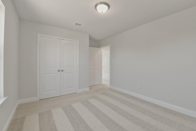 13140 Soaring Forest Dr, Conroe, TX 77302 - unfurnished bedroom with baseboards, light carpet, and a closet
