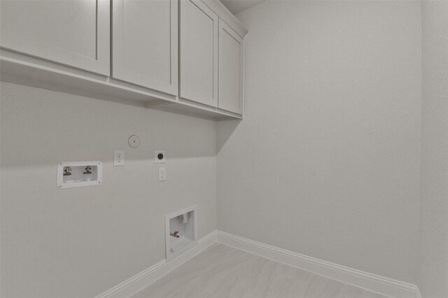 13140 Soaring Forest Dr, Conroe, TX 77302 - laundry area with hookup for a gas dryer, hookup for an electric dryer, cabinet space, baseboards, and washer hookup