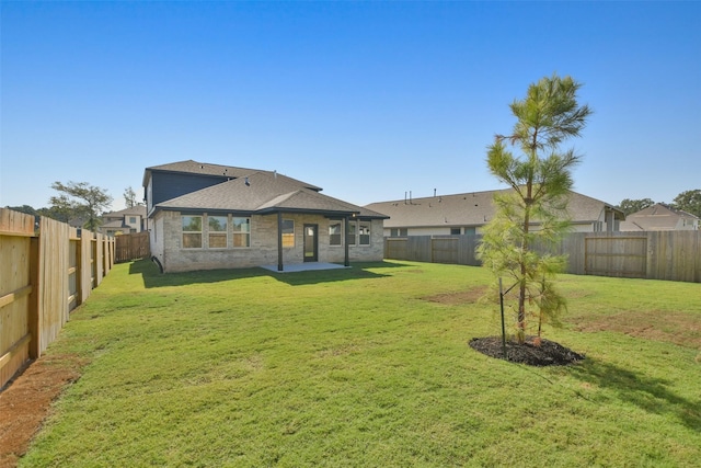 13140 Soaring Forest Dr, Conroe, TX 77302 - back of house with a shingled roof, a patio area, and brick siding