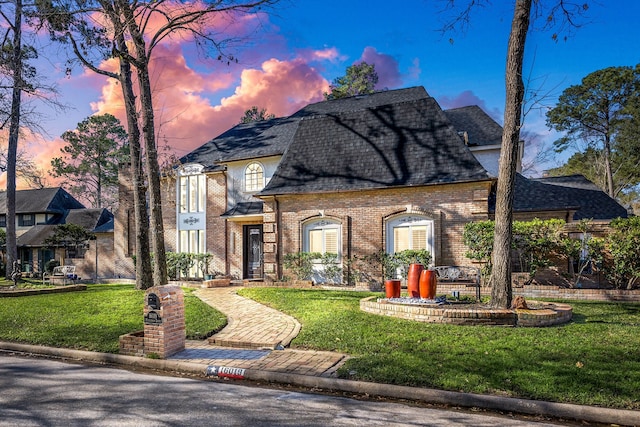 16019 Mickleham Dr, Spring, TX 77379 - french provincial home featuring a shingled roof, a front lawn, and brick siding
