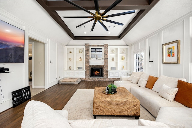 16019 Mickleham Dr, Spring, TX 77379 - living room featuring a ceiling fan, wood finished floors, a brick fireplace, lofted ceiling, and built in features