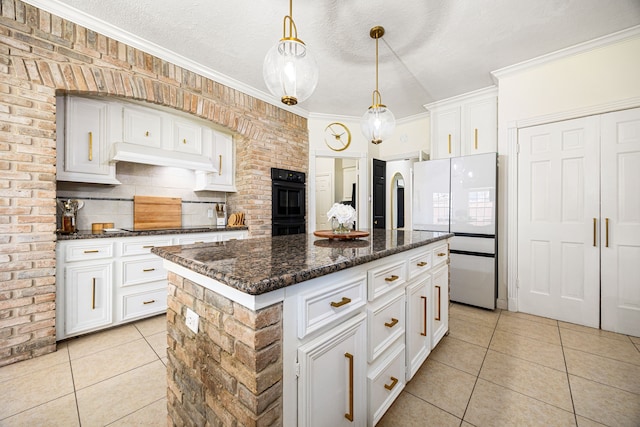 16019 Mickleham Dr, Spring, TX 77379 - kitchen with light tile patterned floors, black appliances, white cabinets, a center island, and ornamental molding