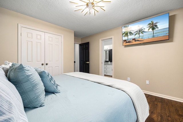 16019 Mickleham Dr, Spring, TX 77379 - bedroom with dark wood-type flooring, baseboards, a closet, ensuite bathroom, and a textured ceiling