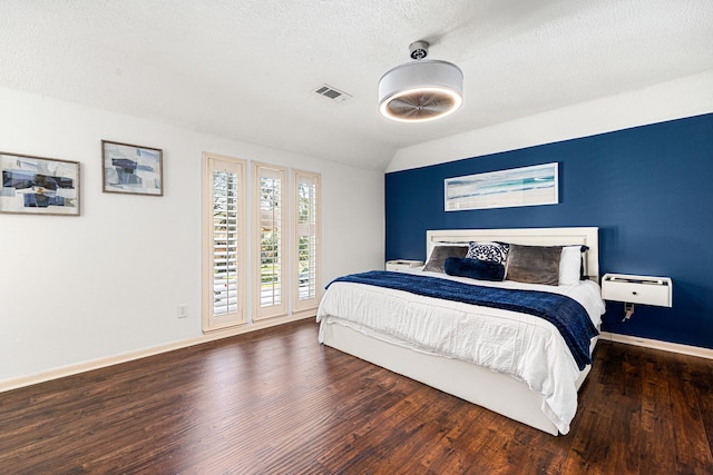 16019 Mickleham Dr, Spring, TX 77379 - bedroom featuring wood finished floors, baseboards, vaulted ceiling, a textured ceiling, and access to outside