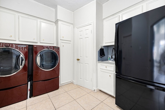 16019 Mickleham Dr, Spring, TX 77379 - laundry room with light tile patterned floors, independent washer and dryer, and a textured ceiling