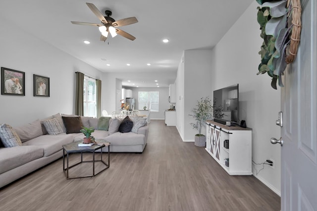 9040 Pecos Pl, Willis, TX 77378 - living area featuring a ceiling fan, wood finished floors, baseboards, and recessed lighting