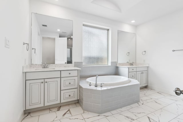 15003 Big Spring Park Dr, Cypress, TX 77433 - full bath with marble finish flooring, a garden tub, baseboards, two vanities, and recessed lighting