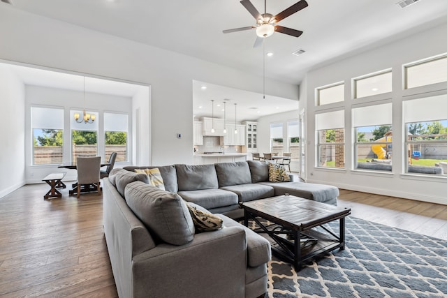 15003 Big Spring Park Dr, Cypress, TX 77433 - living room with wood finished floors, a chandelier, baseboards, ceiling fan, and recessed lighting