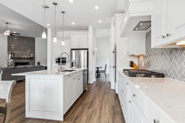 15003 Big Spring Park Dr, Cypress, TX 77433 - kitchen with appliances with stainless steel finishes, ceiling fan, a sink, tasteful backsplash, and white cabinetry