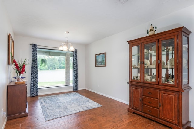 2207 Azalea Cir, Huntsville, TX 77340 - entrance foyer with a chandelier, wood finished floors, and baseboards