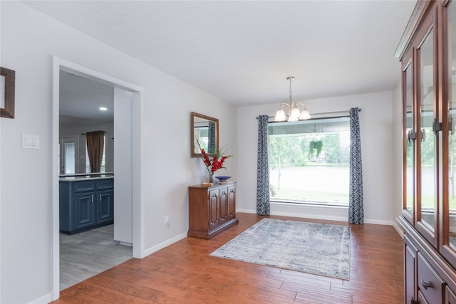 2207 Azalea Cir, Huntsville, TX 77340 - foyer featuring a chandelier, wood finished floors, and baseboards