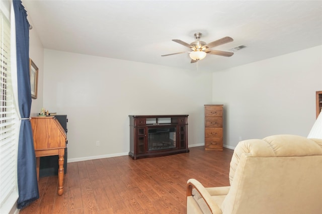 2207 Azalea Cir, Huntsville, TX 77340 - living area with ceiling fan, wood finished floors, baseboards, and a glass covered fireplace