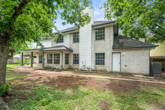 2502 Sea Horse Ct, Seabrook, TX 77586 - rear view of property with central AC, a chimney, brick siding, fence, and a patio area