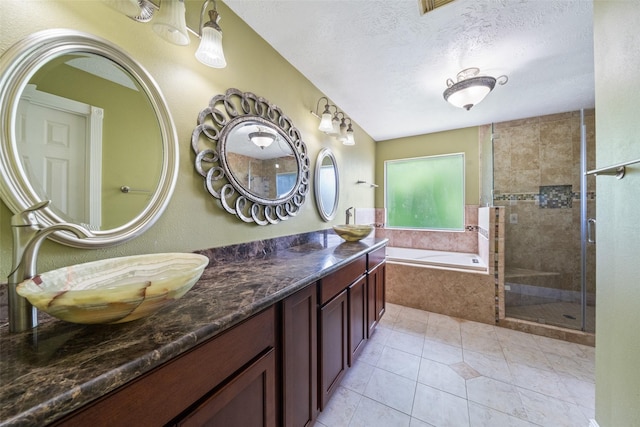 2502 Sea Horse Ct, Seabrook, TX 77586 - bathroom with a bath, a shower stall, tile patterned floors, a textured ceiling, and double vanity