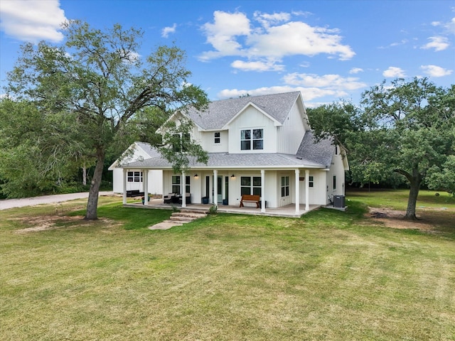 8253 Carolyn St, Santa Fe, TX 77517 - back of property with roof with shingles, central AC, a yard, and a porch