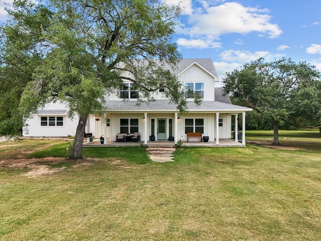 8253 Carolyn St, Santa Fe, TX 77517 - back of house with a lawn, board and batten siding, a patio, and a shingled roof