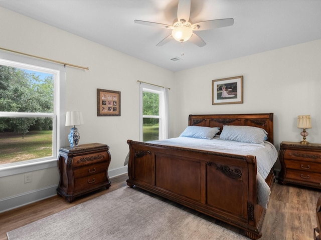 8253 Carolyn St, Santa Fe, TX 77517 - bedroom featuring multiple windows and wood finished floors