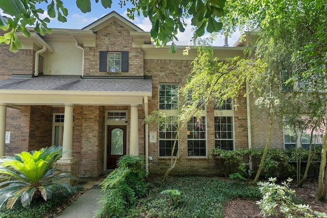 27 Medley Ln, The Woodlands, TX 77382 - view of front of property with brick siding, a shingled roof, and a porch