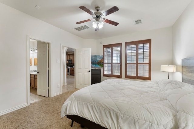 27 Medley Ln, The Woodlands, TX 77382 - bedroom featuring light colored carpet, arched walkways, connected bathroom, and ceiling fan