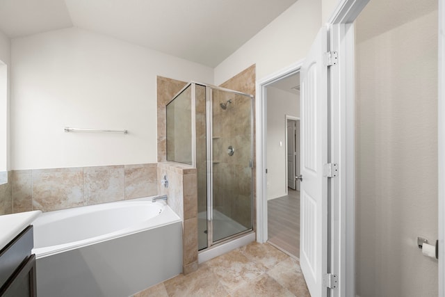 3105 Zachary Bay Ln, League City, TX 77539 - bathroom featuring a stall shower, a garden tub, tile patterned floors, vanity, and vaulted ceiling