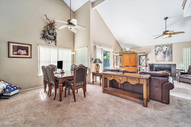 15415 Swan Creek Dr, Houston, TX 77095 - dining space with ceiling fan, high vaulted ceiling, carpet, and a warm lit fireplace