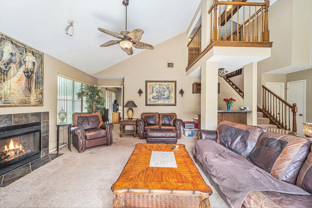 15415 Swan Creek Dr, Houston, TX 77095 - living room with high vaulted ceiling, carpet, stairway, a ceiling fan, and a tile fireplace