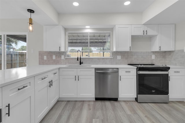18010 Santolina Ln, Katy, TX 77449 - kitchen with appliances with stainless steel finishes, a sink, light countertops, white cabinets, and recessed lighting