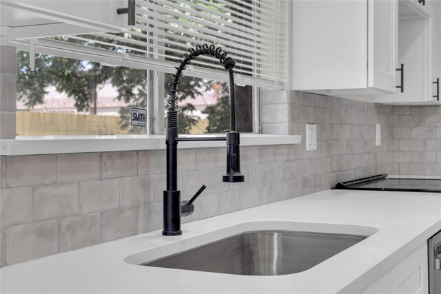 18010 Santolina Ln, Katy, TX 77449 - kitchen view of a sink, tasteful backsplash, and white cabinetry